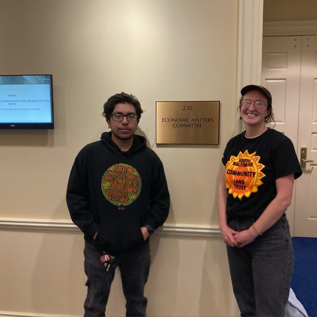 Two SBCLT staff members wearing an SBCLT T-shirt and an SBCLT hoodie